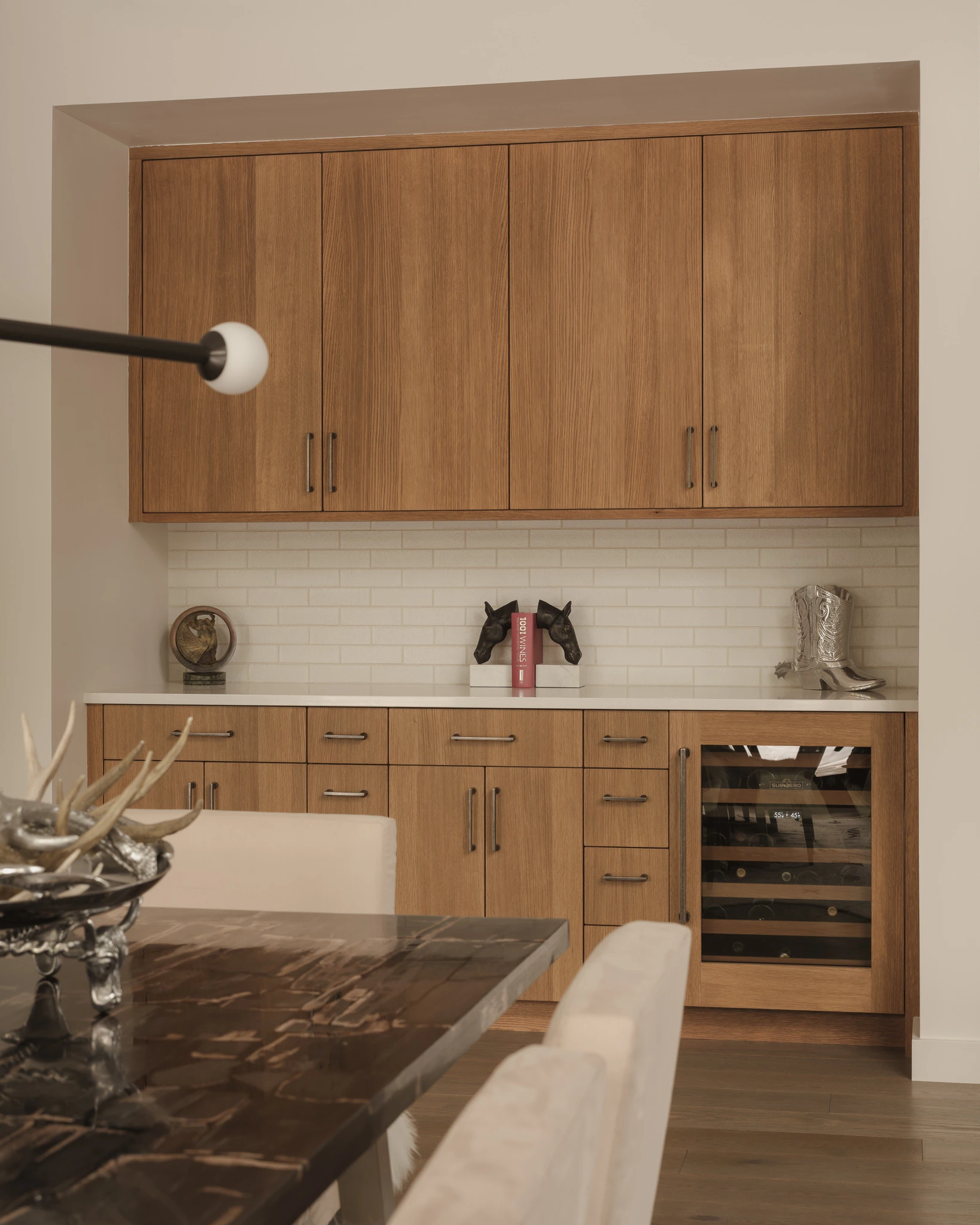 Wet bar with wine refrigerator and walnut cabinetry — interior design photography Big Sky Montana, Speedwell Cabin